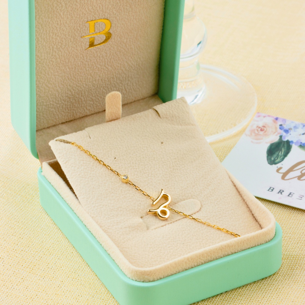 box shot of Gold Horoscope with diamond bracelet